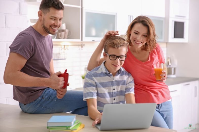 Family looking at laptop