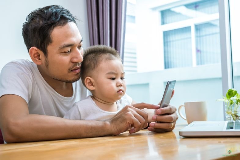 Father and son looking at the phone